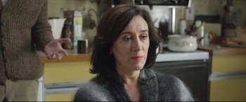 Movie still from “Sing Street” (2016), directed by John Carney – A person sitting in a room; Close Up shot, Over the shoulder angle