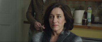 Movie still from “Sing Street” (2016), directed by John Carney – A person sitting in front of another person; Close Up shot, Over the shoulder angle