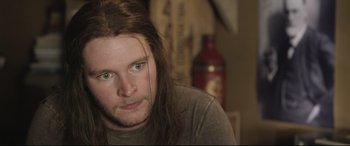 Movie still from “Sing Street” (2016), directed by John Carney – A person with long brown hair; Close Up shot, Over the shoulder angle