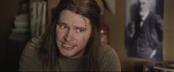 Movie still from “Sing Street” (2016), directed by John Carney – A person with long brown hair; Close Up shot, Over the shoulder angle