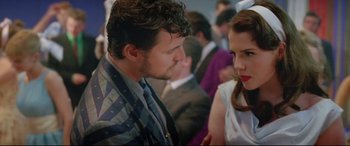 Movie still from “Sing Street” (2016), directed by John Carney – A man and a woman talking to each other; Medium shot, Over the shoulder angle