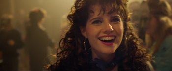 Movie still from “Sing Street” (2016), directed by John Carney – A person with curly brown hair; Close Up shot, Over the shoulder angle