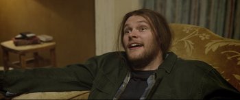 Movie still from “Sing Street” (2016), directed by John Carney – A person with long hair and a beard; Close Up shot, Over the shoulder angle