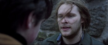 Movie still from “Sing Street” (2016), directed by John Carney – A man with long hair talking to another man; Close Up shot, Over the shoulder angle