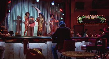 Movie still from “Sister Act” (1992), directed by Emile Ardolino – A group of women performing on stage in front of an audience; Wide shot, Low angle