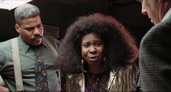 Movie still from “Sister Act” (1992), directed by Emile Ardolino – A woman with a big afro standing next to a man; Close Up shot, Low angle