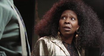 Movie still from “Sister Act” (1992), directed by Emile Ardolino – An older woman with big curly hair looking up at the sky; Close Up shot, Low angle