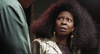 Movie still from “Sister Act” (1992), directed by Emile Ardolino – A woman with a very large afro looking surprised; Close Up shot, Over the shoulder angle