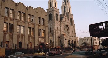 Movie still from “Sister Act” (1992), directed by Emile Ardolino – A large church with a large clock on the side of the building; Extreme Wide shot, Low angle