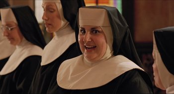 Movie still from “Sister Act” (1992), directed by Emile Ardolino – Two women dressed as nuns smiling for the camera; Close Up shot, Over the shoulder angle