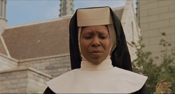 Movie still from “Sister Act” (1992), directed by Emile Ardolino – A woman in a nun's outfit is looking sad; Close Up shot, Low angle