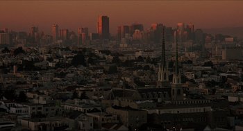 Movie still from “Sister Act” (1992), directed by Emile Ardolino – A view of a city skyline at sunset; Extreme Wide shot, High angle
