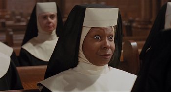 Movie still from “Sister Act” (1992), directed by Emile Ardolino – A woman in a nun's outfit looking surprised; Close Up shot, Low angle