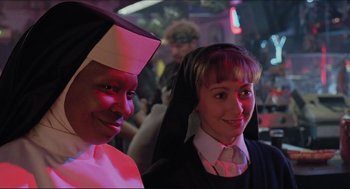 Movie still from “Sister Act” (1992), directed by Emile Ardolino – A nun and a nun's sister posing for a picture; Close Up shot, Low angle