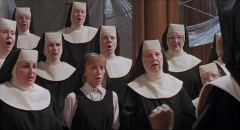 Movie still from “Sister Act” (1992), directed by Emile Ardolino – A group of nuns singing in front of a mirror; Medium shot, High angle