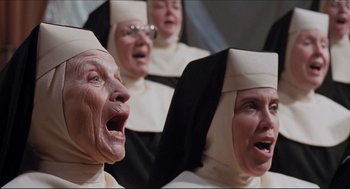 Movie still from “Sister Act” (1992), directed by Emile Ardolino – A group of nuns singing together in a choir; Close Up shot, Low angle