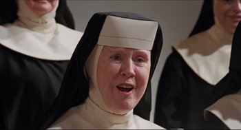 Movie still from “Sister Act” (1992), directed by Emile Ardolino – An older woman wearing a nun's outfit; Close Up shot, Low angle