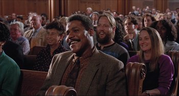 Movie still from “Sister Act” (1992), directed by Emile Ardolino – A group of people sitting in a room; Medium shot, Low angle