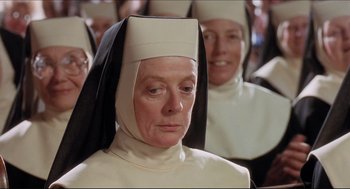 Movie still from “Sister Act” (1992), directed by Emile Ardolino – A woman in a nun's outfit looking at the camera; Close Up shot, High angle