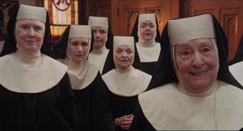 Movie still from “Sister Act” (1992), directed by Emile Ardolino – A group of women dressed in nun's clothes; Close Up shot, Low angle