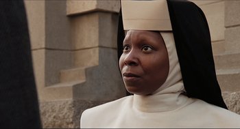 Movie still from “Sister Act” (1992), directed by Emile Ardolino – A woman in a nun's outfit looking into the distance; Close Up shot, Low angle