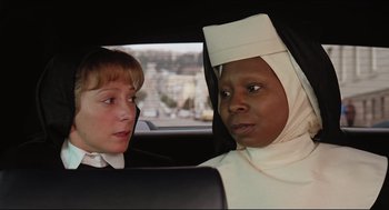 Movie still from “Sister Act” (1992), directed by Emile Ardolino – Two women in a car wearing nun's clothes; Close Up shot, Over the shoulder angle