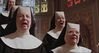 Movie still from “Sister Act” (1992), directed by Emile Ardolino – A group of three women dressed as nuns singing; Close Up shot, Low angle