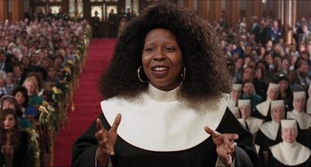 Movie still from “Sister Act” (1992), directed by Emile Ardolino – A woman in a nun's outfit is smiling for the camera; Close Up shot, Low angle