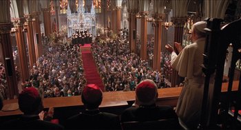 Movie still from “Sister Act” (1992), directed by Emile Ardolino – A crowd of people sitting in front of a red carpet; Extreme Wide shot, High angle