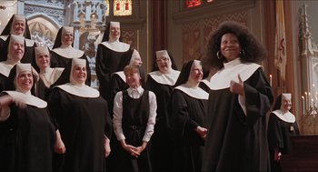 Movie still from “Sister Act” (1992), directed by Emile Ardolino – A group of women dressed as nuns in a church; Wide shot, High angle