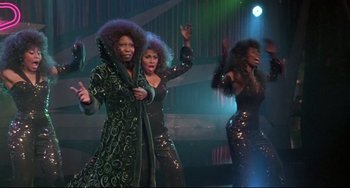 Movie still from “Sister Act 2: Back in the Habit” (1993), directed by Bill Duke – A group of women are performing on stage; Medium shot, Low angle