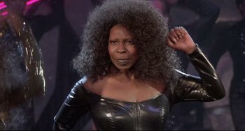 Movie still from “Sister Act 2: Back in the Habit” (1993), directed by Bill Duke – An african american woman in a black leather outfit; Close Up shot, Low angle
