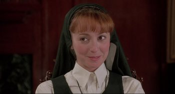 Movie still from “Sister Act 2: Back in the Habit” (1993), directed by Bill Duke – A woman wearing a nun's veil and a white shirt; Close Up shot, Low angle