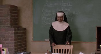 Movie still from “Sister Act 2: Back in the Habit” (1993), directed by Bill Duke – A nun standing in front of a chalkboard; Medium shot, Low angle