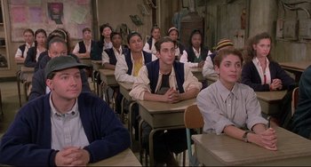 Movie still from “Sister Act 2: Back in the Habit” (1993), directed by Bill Duke – A group of young men sitting at desks in a classroom; Medium shot, High angle