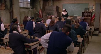 Movie still from “Sister Act 2: Back in the Habit” (1993), directed by Bill Duke – A group of people sitting in a classroom; Wide shot, High angle