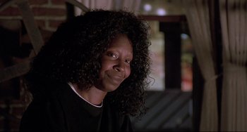 Movie still from “Sister Act 2: Back in the Habit” (1993), directed by Bill Duke – A person wearing a black shirt with long curly hair; Close Up shot, Low angle