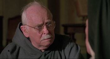 Movie still from “Sister Act 2: Back in the Habit” (1993), directed by Bill Duke – An old man with glasses and a mustache; Close Up shot, Over the shoulder angle