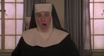 Movie still from “Sister Act 2: Back in the Habit” (1993), directed by Bill Duke – A woman dressed as a nun with her mouth wide open; Close Up shot, Low angle