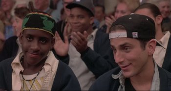 Movie still from “Sister Act 2: Back in the Habit” (1993), directed by Bill Duke – A group of young men sitting next to each other; Close Up shot, Low angle