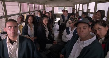 Movie still from “Sister Act 2: Back in the Habit” (1993), directed by Bill Duke – A group of people sitting on a bus; Wide shot, High angle