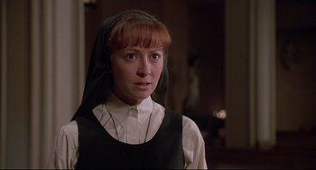 Movie still from “Sister Act 2: Back in the Habit” (1993), directed by Bill Duke – A woman in a nun's outfit looking at the camera; Close Up shot, Low angle