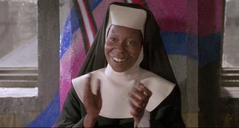 Movie still from “Sister Act 2: Back in the Habit” (1993), directed by Bill Duke – A woman dressed as a nun smiling for the camera; Close Up shot, Low angle