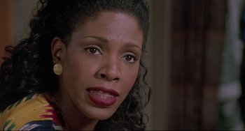 Movie still from “Sister Act 2: Back in the Habit” (1993), directed by Bill Duke – A person with curly black hair; Close Up shot, High angle