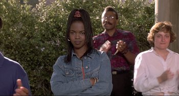Movie still from “Sister Act 2: Back in the Habit” (1993), directed by Bill Duke – A young girl with braids standing in front of a man; Close Up shot, Over the shoulder angle