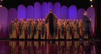 Movie still from “Sister Act 2: Back in the Habit” (1993), directed by Bill Duke – A large group of men in robes and hats; Extreme Wide shot, High angle