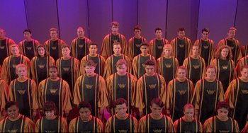 Movie still from “Sister Act 2: Back in the Habit” (1993), directed by Bill Duke – A group of young men standing next to each other in front of a purple wall; Wide shot, High angle