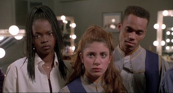 Movie still from “Sister Act 2: Back in the Habit” (1993), directed by Bill Duke – A group of people standing next to each other in a room; Close Up shot, High angle