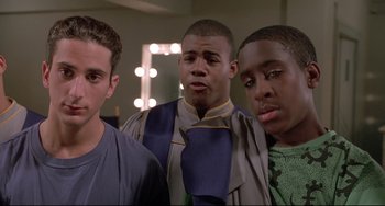 Movie still from “Sister Act 2: Back in the Habit” (1993), directed by Bill Duke – A group of young men standing next to each other in a room; Close Up shot, Low angle