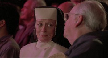 Movie still from “Sister Act 2: Back in the Habit” (1993), directed by Bill Duke – An older man and a woman dressed as a nun; Close Up shot, Over the shoulder angle